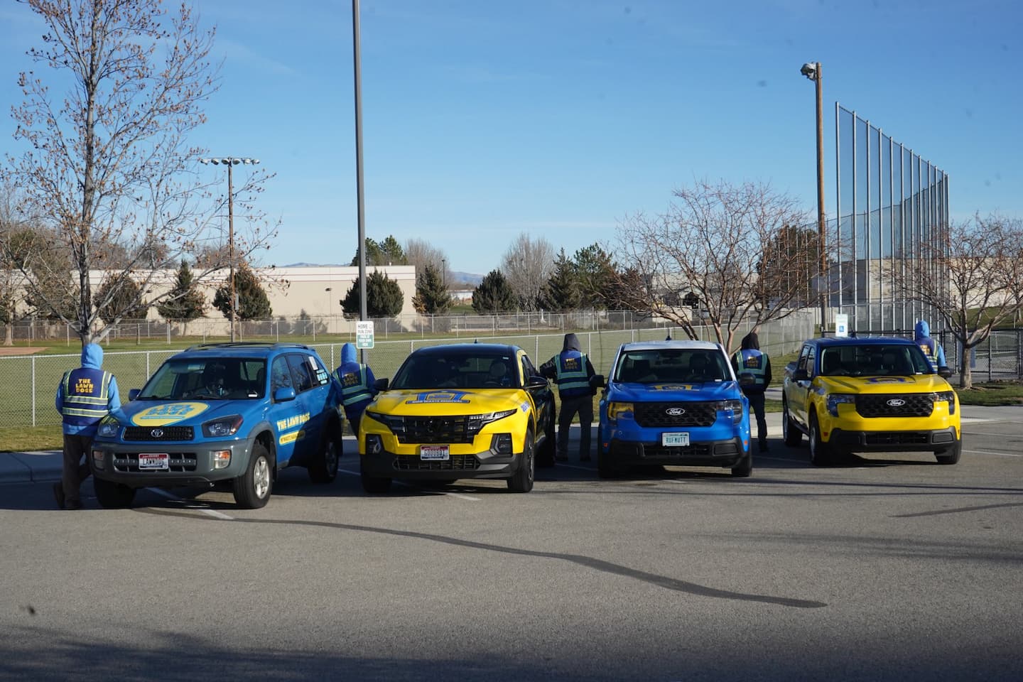 The Lawn Dogs crew and fleet trucks together, the team now serving former Scoop Dog Idaho clients