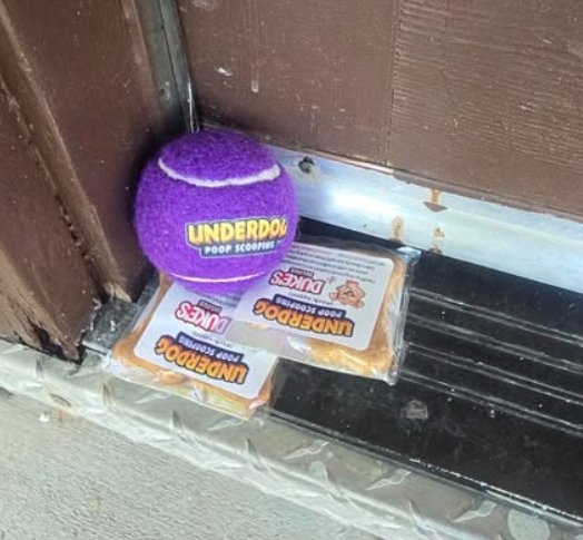 Underdog Poop Scoop branded tennis ball and dog treats left at a client door before The Lawn Dogs merger